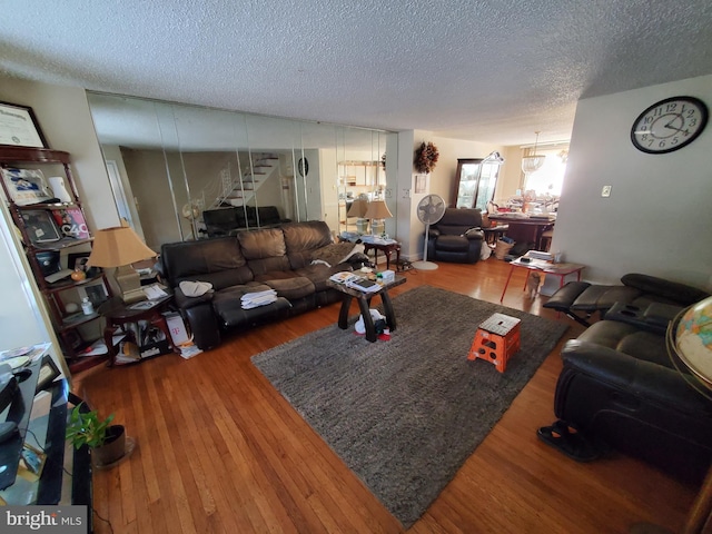 living room with hardwood / wood-style floors and a textured ceiling