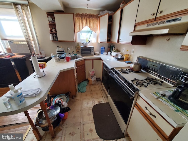 kitchen with white cabinetry, white range with gas stovetop, and sink