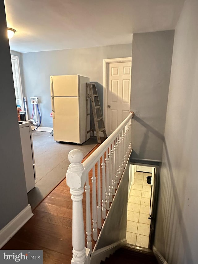 stairway with hardwood / wood-style floors