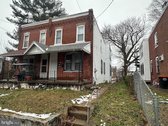 view of property featuring covered porch