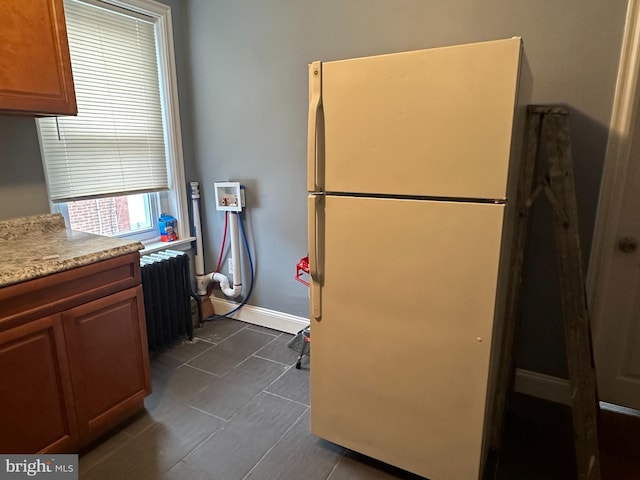 kitchen featuring white fridge and radiator