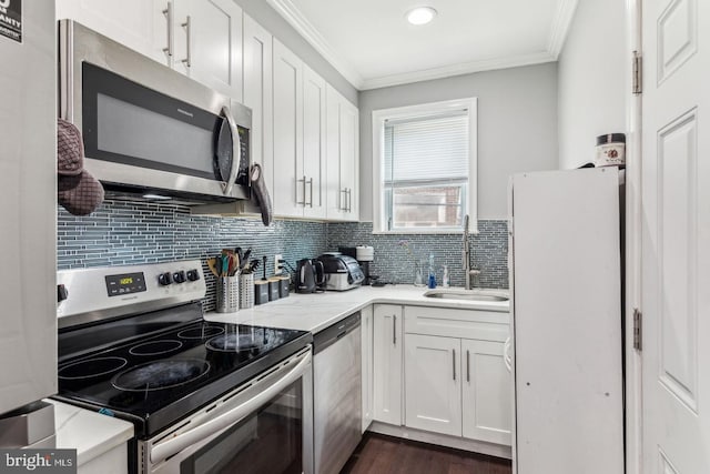 kitchen featuring white cabinets, decorative backsplash, sink, and stainless steel appliances