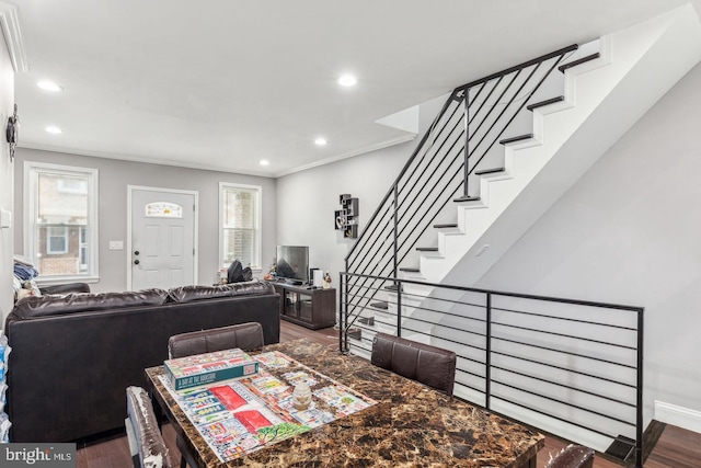 dining area with hardwood / wood-style floors and crown molding