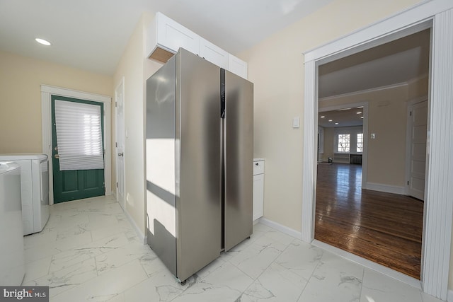 hall with washing machine and clothes dryer