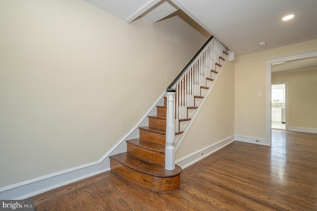 stairs featuring hardwood / wood-style floors