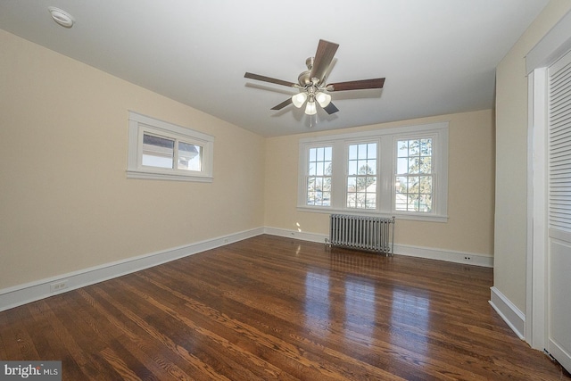 unfurnished bedroom featuring ceiling fan, dark hardwood / wood-style floors, and radiator