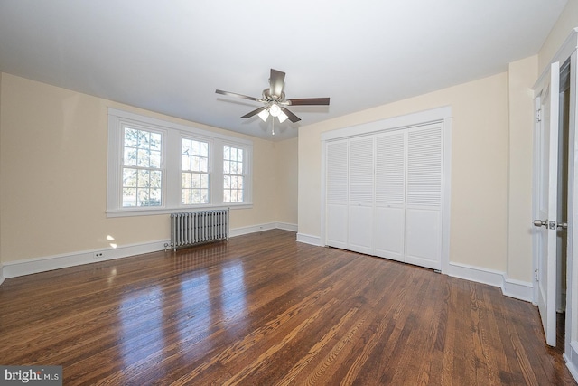 unfurnished bedroom featuring radiator heating unit, a closet, dark hardwood / wood-style floors, and ceiling fan