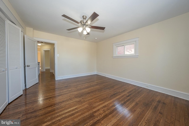 unfurnished bedroom featuring a closet, ceiling fan, and dark wood-type flooring