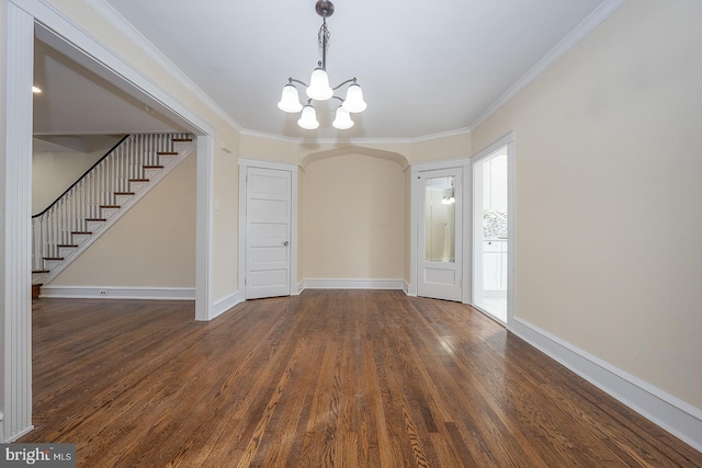 unfurnished dining area with a notable chandelier, dark hardwood / wood-style floors, and ornamental molding