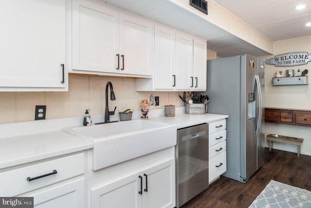 kitchen with white cabinetry, sink, dark hardwood / wood-style floors, and appliances with stainless steel finishes