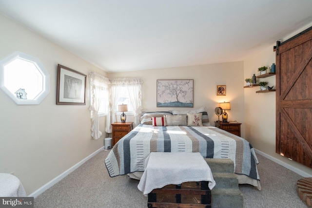 carpeted bedroom featuring a barn door