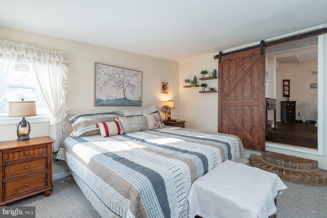 carpeted bedroom with a barn door