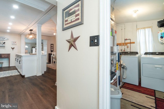 laundry area featuring dark wood-type flooring and washing machine and clothes dryer