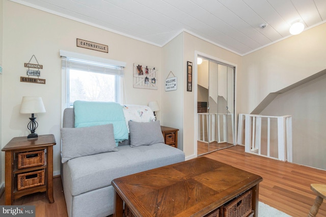 living room with hardwood / wood-style floors and crown molding