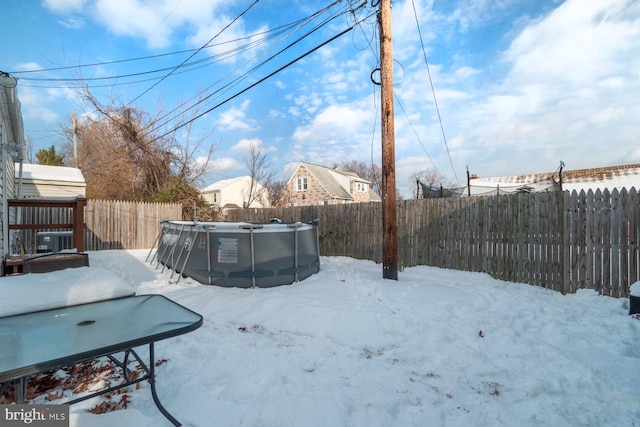 yard covered in snow featuring a covered pool