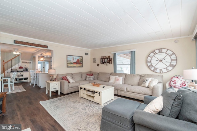 living room featuring dark hardwood / wood-style floors, ceiling fan, and ornamental molding