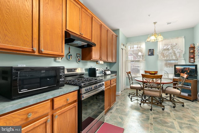 kitchen featuring decorative light fixtures, an inviting chandelier, and stainless steel range with gas stovetop