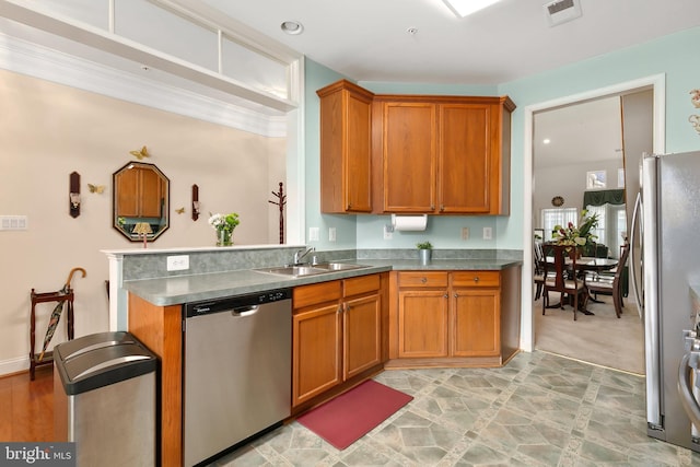 kitchen with kitchen peninsula, sink, and appliances with stainless steel finishes