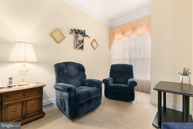 sitting room with ornamental molding and light carpet