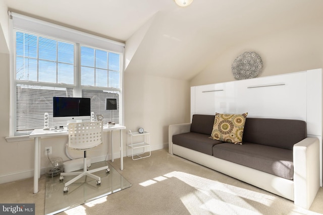 carpeted office featuring vaulted ceiling