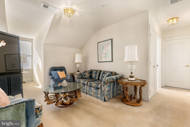 carpeted living room featuring vaulted ceiling