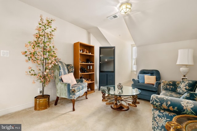 sitting room with lofted ceiling and carpet floors