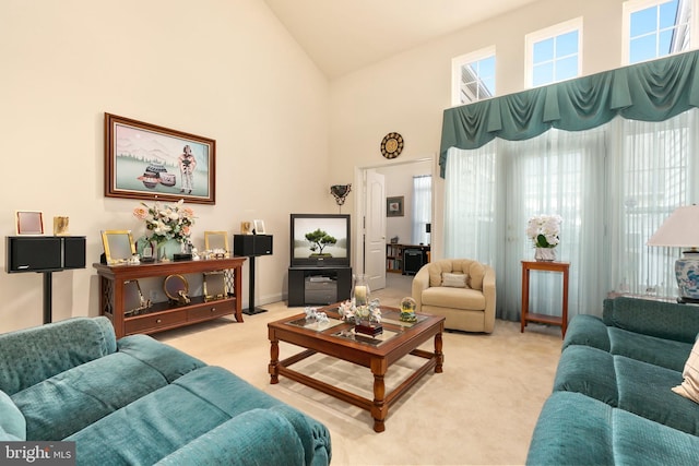 living room with light colored carpet and a high ceiling