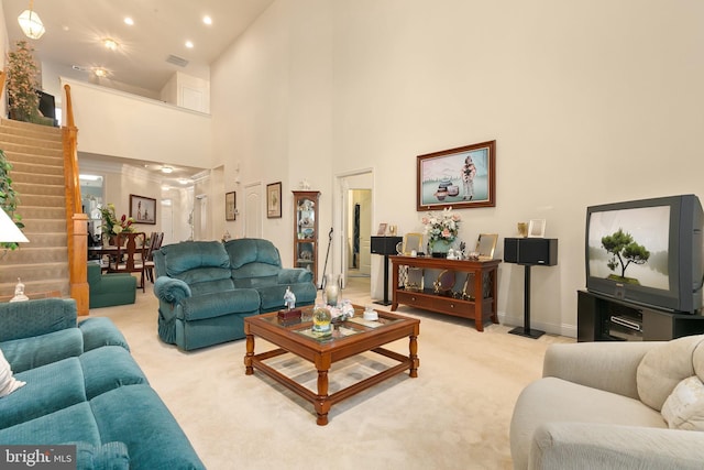 living room with light carpet and a towering ceiling