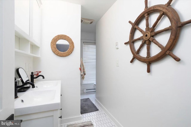 bathroom with tile patterned flooring, vanity, and baseboard heating