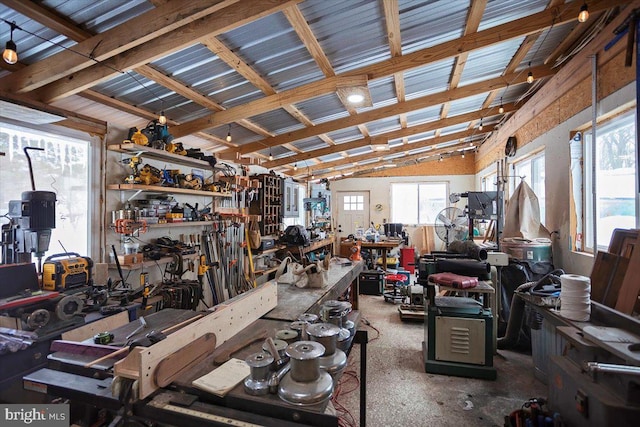 miscellaneous room featuring a workshop area and vaulted ceiling