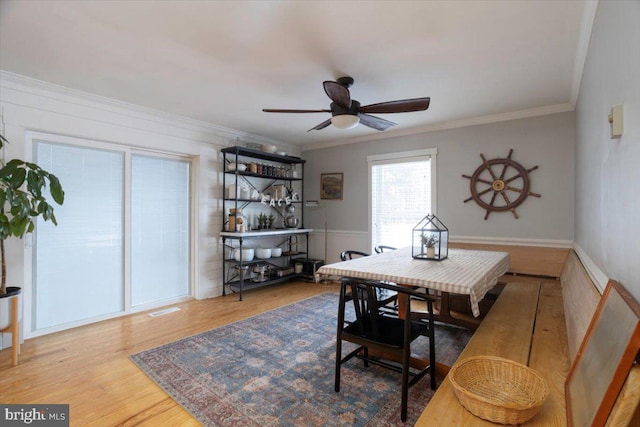 dining area with hardwood / wood-style flooring, ceiling fan, and ornamental molding