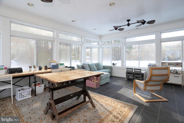 sunroom featuring ceiling fan