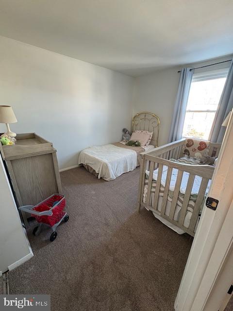 bedroom featuring dark colored carpet