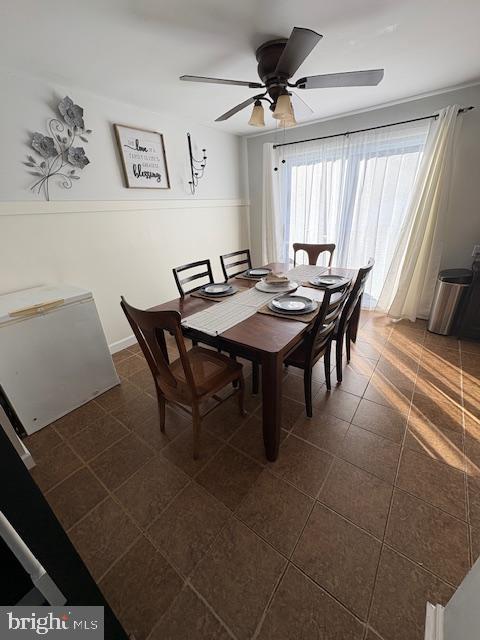 tiled dining area featuring ceiling fan