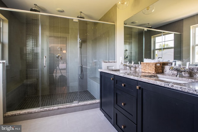 bathroom with tile patterned floors, vanity, and a shower with shower door