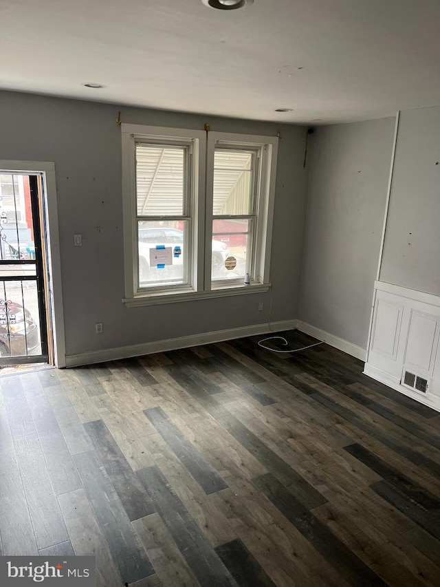 empty room featuring dark hardwood / wood-style flooring