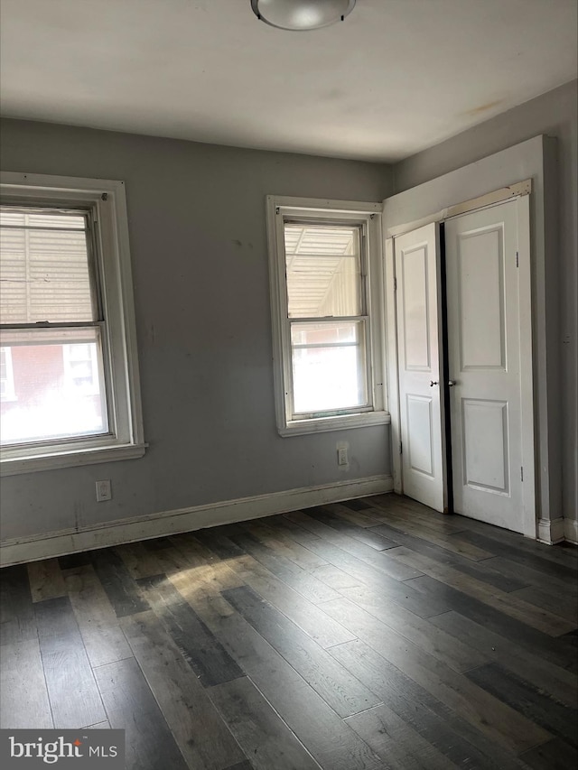 unfurnished room featuring dark hardwood / wood-style floors