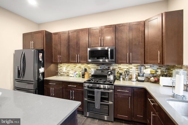 kitchen featuring tasteful backsplash, dark brown cabinetry, sink, and stainless steel appliances