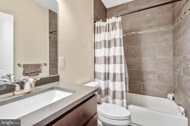 full bathroom featuring vanity, shower / bath combination with curtain, and toilet