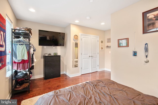 bedroom featuring dark hardwood / wood-style flooring and a closet