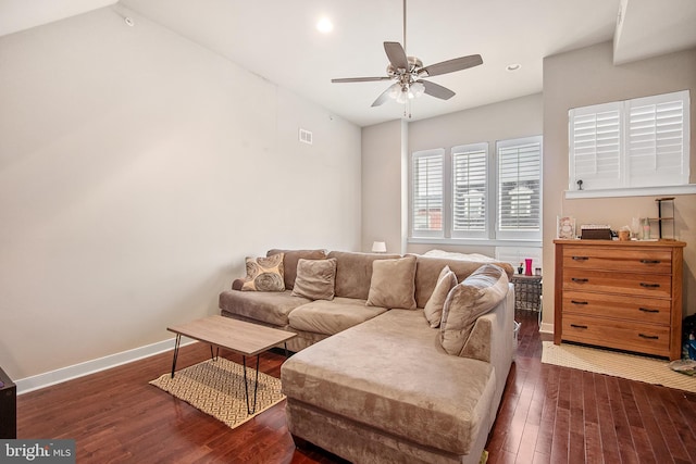 living room featuring ceiling fan, dark wood-type flooring, and vaulted ceiling