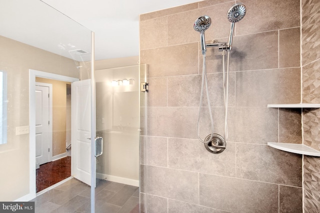 bathroom featuring a shower with shower door