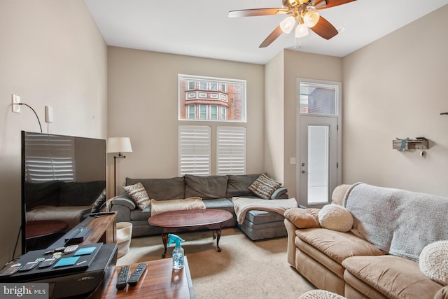 living room featuring light carpet and ceiling fan