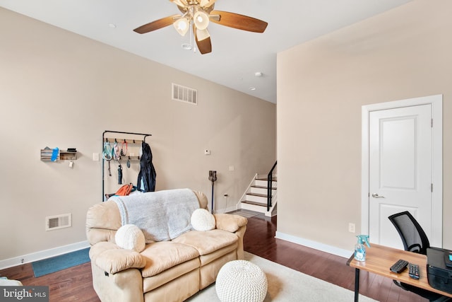 living room featuring dark hardwood / wood-style flooring and ceiling fan