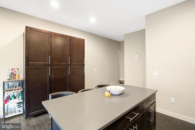 kitchen featuring dark brown cabinets and a center island