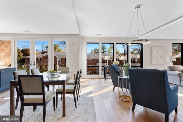 dining space featuring visible vents, a healthy amount of sunlight, and light wood-style flooring