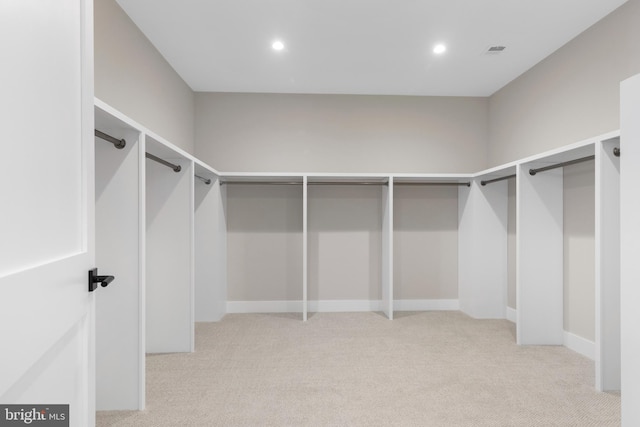 spacious closet featuring light colored carpet and visible vents