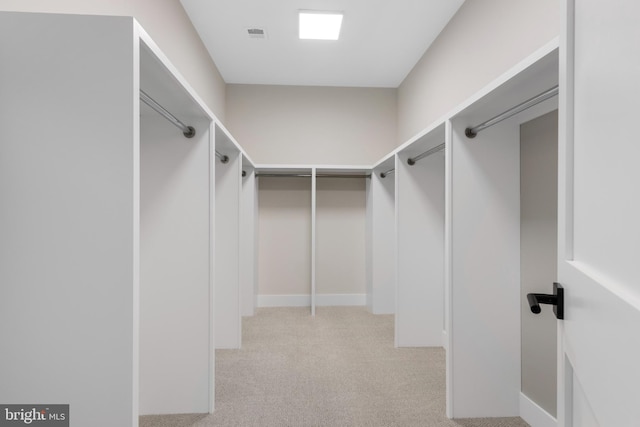 spacious closet featuring light carpet