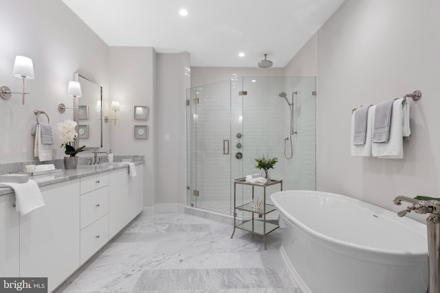 full bathroom with a stall shower, marble finish floor, vanity, a freestanding tub, and recessed lighting