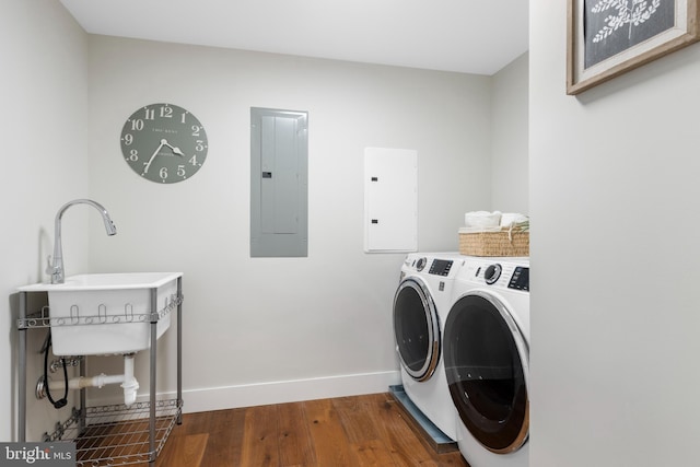 clothes washing area with laundry area, electric panel, independent washer and dryer, and dark wood-style flooring